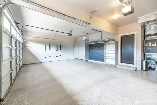 3 car garage with well designed storage, EV charger, epoxy floor & wall mounted bike racks.