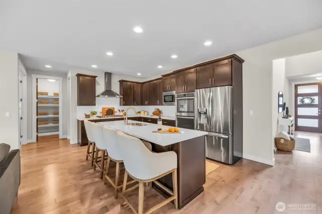 Kitchen with an eat-in island & stainless steel appliances.