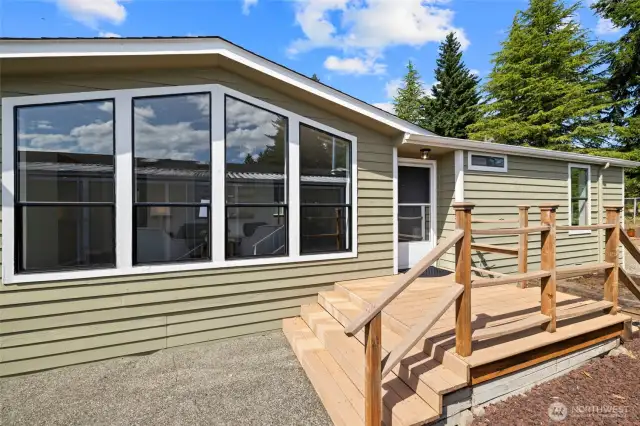 Rare find, overlooking the 3rd tee box at Walter Hall Golf Course. Inviting front porch entrance with patio and side walk up.