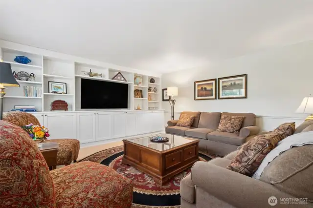 Upon entry, off to the left is what could be called the formal living room, here, we've discovered its perfect use is as a dedicated TV/Media room! -- Look at that great recently added cabinet system!