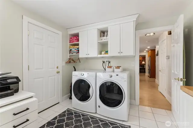Huge mudroom / laundry room conveniently off the main floor living space with door to the backyard.