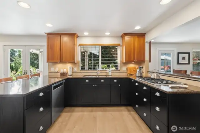 With loads of counter space, a breakfast bar/prep peninsula, Cherry upper cabinets, black lower cabinets, new appliances and gas stove top!