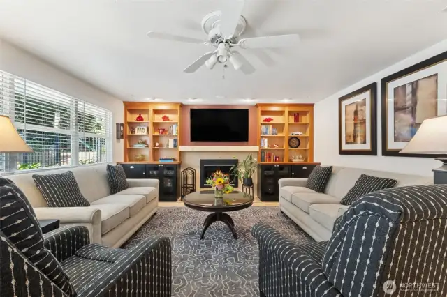 The family room fantastic installed cabinetry & shelving plus the gorgeous titled gas fireplace.