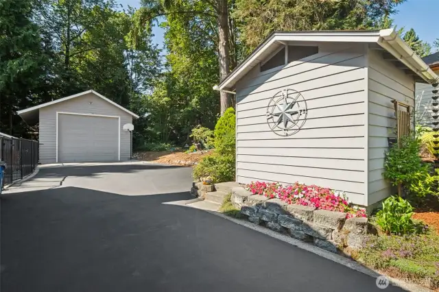Long just re-sealed driveway to the right of the house, and to the right of the gated backyard. Includes garden shed AND massive 32x24 detached shop!