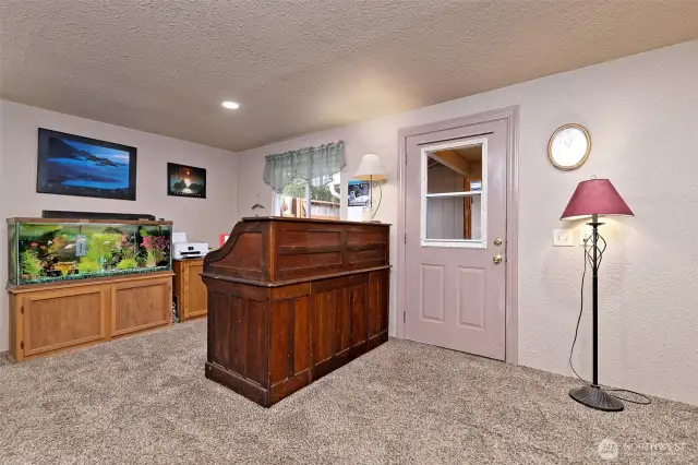 The fully-finished bonus room, with a door leading outside.