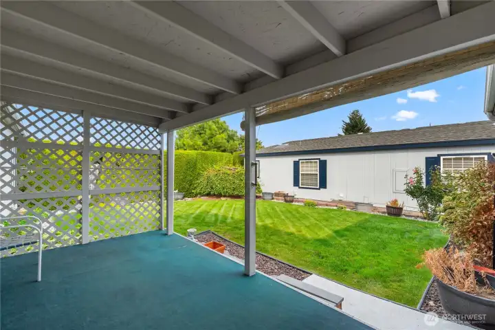 Covered Porch off Living Room with Beautifully Landscaped Backyard