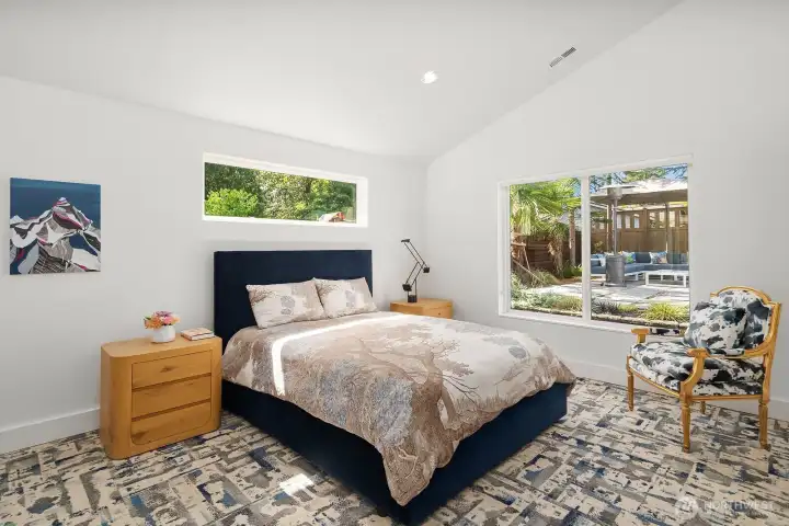 Spacious primary bedroom w/ carpet tiles