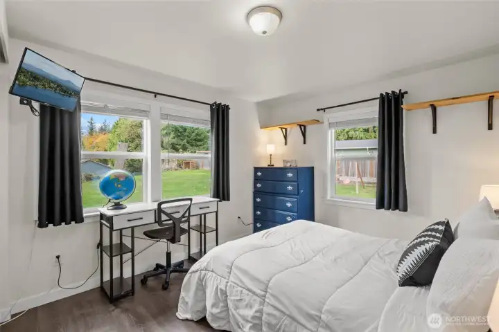 Second bedroom with vinyl plank flooring and fresh paint.