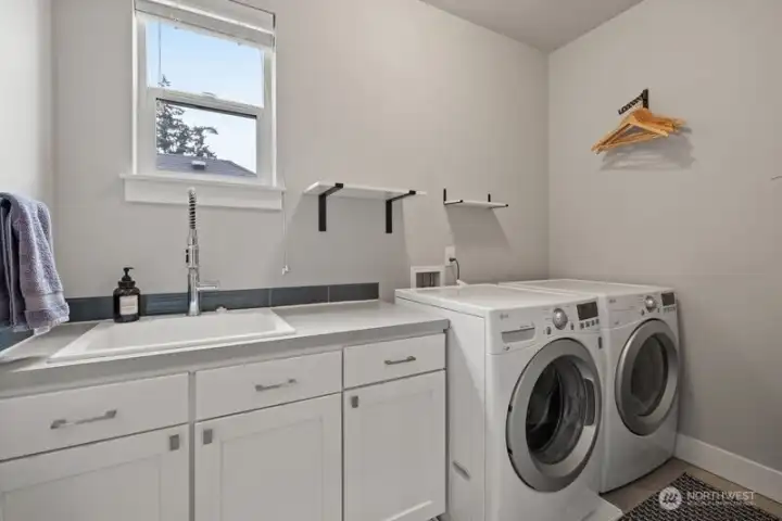 2nd floor laundry with storage, utility sink and washer and dryer