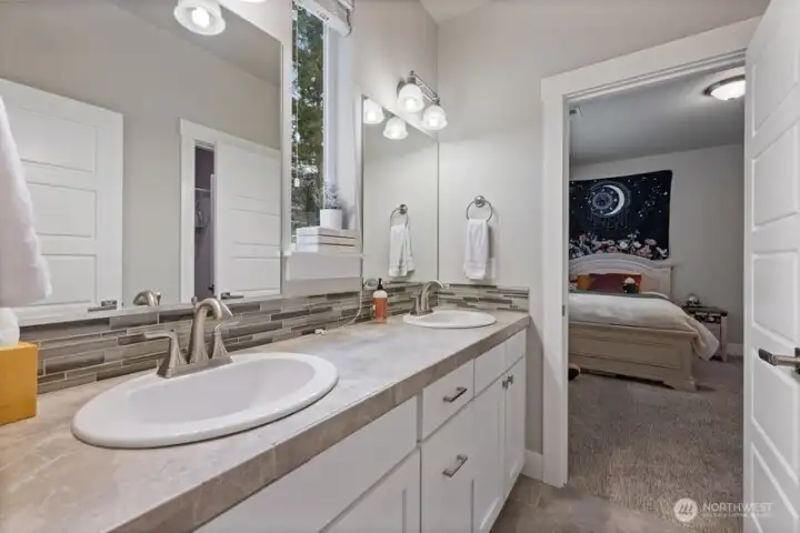 Double sinks in the Jack and Jill bathroom, tub/shower and toilet in private room