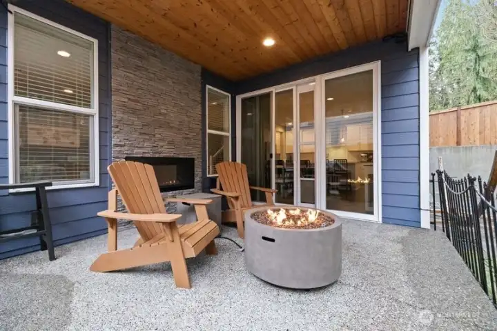 Covered patio with indoor/outdoor gas fireplace, mounted heaters, plumbed for gas grill