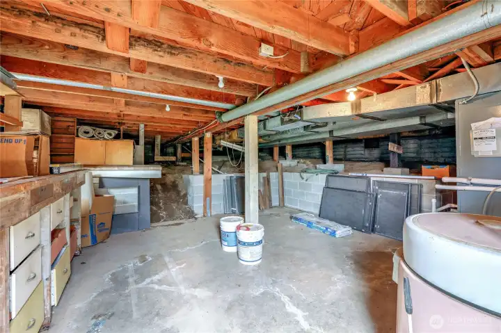The unfinished basement has a work bench.