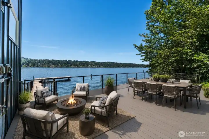 Step outside to an expansive waterfront deck designed for entertaining, featuring dedicated spaces for dining, lounging, and enjoying unobstructed lake views. With direct access to the dock and plenty of room to gather, this outdoor space extends your living experience right to the water’s edge. Virtually staged.