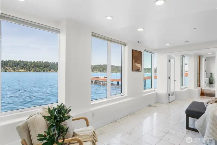 Walls of windows line the Primary Suite, creating front-row views of the water and adding the space with natural light throughout the day. A rare opportunity to experience waterfront living from the comfort of your own private retreat.