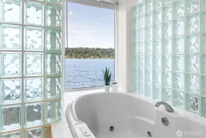 Sink into the jacuzzi bathtub while taking in panoramic waterfront views framed by dramatic glass block accents. This spa-inspired retreat transforms everyday moments into something extraordinary.