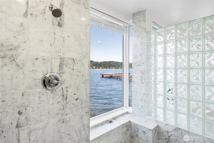 The walk-in shower delivers a one-of-a-kind experience with marble finishes, waterfront views, and glass block details that create privacy without sacrificing light. Start and end your day surrounded by water views from nearly every angle.