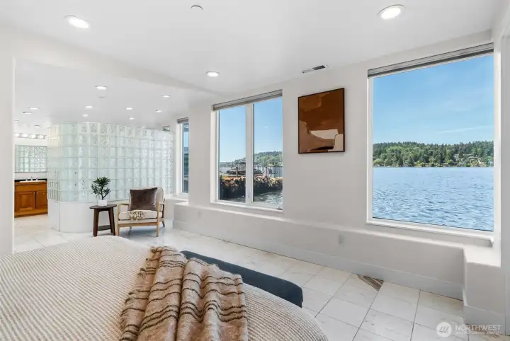This spacious Primary Suite offers room to relax, recharge, and enjoy uninterrupted waterfront scenery from the comfort of your bed. Marble tile flooring, recessed lighting, and bright open spaces create a peaceful escape.