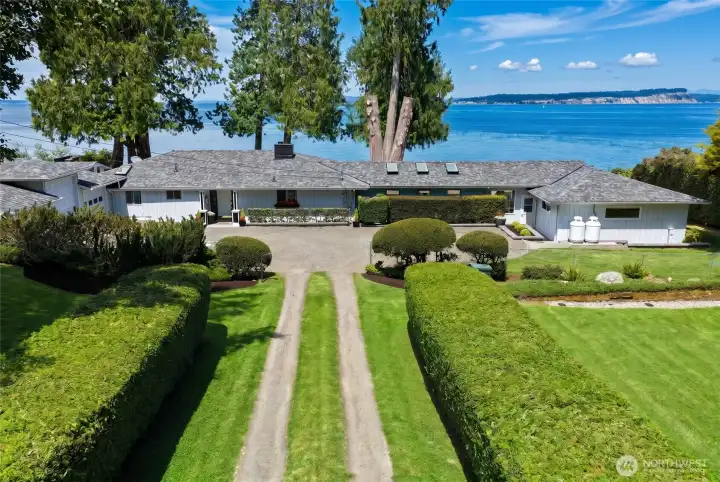 A quiet, private drive lined with mature landscaping and fruit trees welcomes you home. A quiet, private drive lined with mature landscaping and fruit trees welcomes you home.