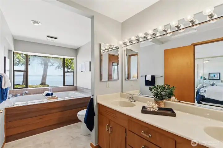 Relax in the primary bathroom, where a soaking tub frames tranquil views of Puget Sound. Relax in the primary bathroom, where a soaking tub frames tranquil views of Puget Sound.