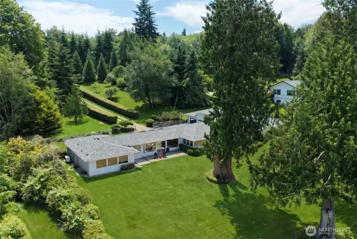 An aerial perspective showcases the home's beautiful setting and expansive grounds. An aerial perspective showcases the home's beautiful setting and expansive grounds.