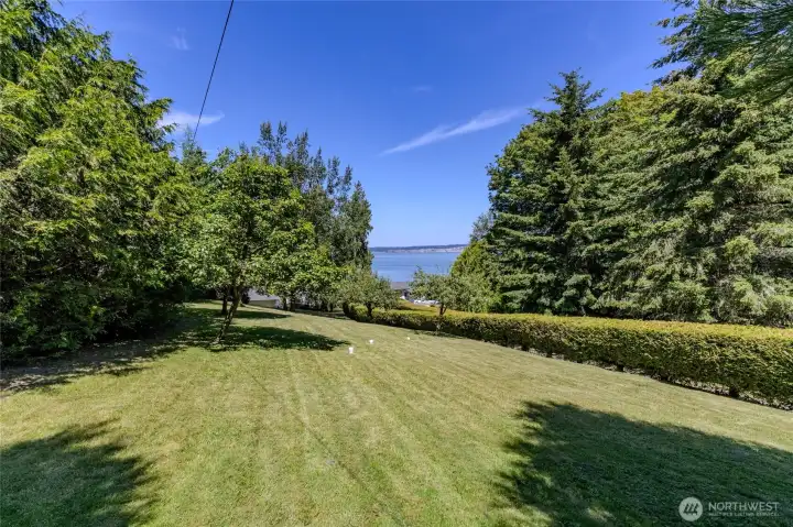 Mature landscaping and fruit trees, including apple, peach, pear and sour cherry, create a welcoming front yard. Mature landscaping and fruit trees, including apple, peach, pear and sour cherry, create a welcoming front yard.