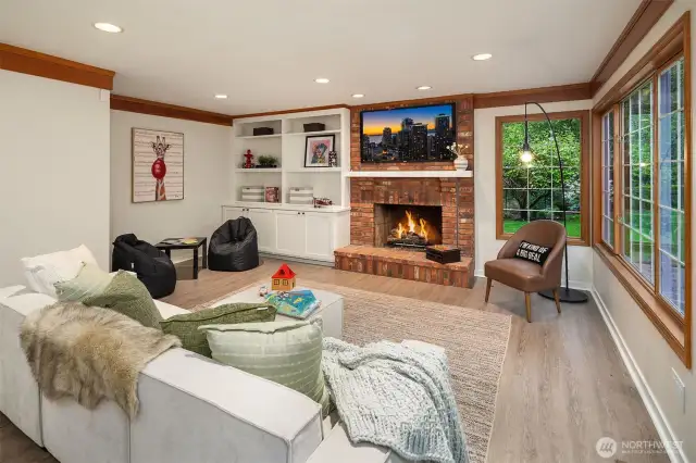 Expansive family / bonus room with cozy fireplace, new flooring