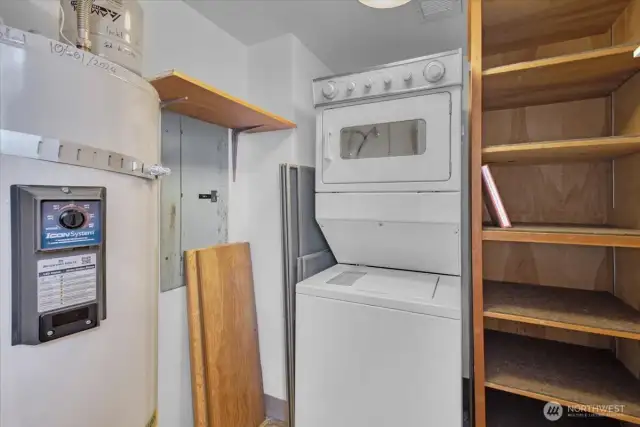 The laundry room has plenty of storage and a brand new hot water tank. There is also a large storage locker in the building next door.