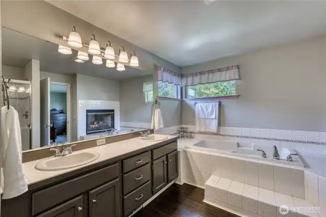 Double vanties and a soaking tub with tile surround.  Grab a book and relax.