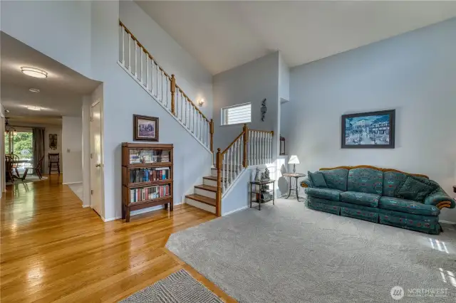 Entry way with beautiful hardwoods floors that continue up the stairs and new carpet throughout the home.