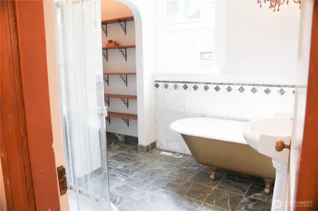 Arched ceiling and marble tile keep the period charm