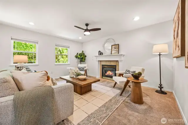 Family room, with a cozy gas fireplace, new ceiling fan & warm light.