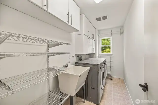 Main floor laundry room with plenty of storage.
