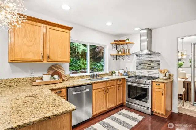 Spacious & stylish kitchen with plenty of storage, newer stainless steel appliances & a great view into the backyard.