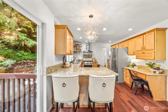 Kitchen with eat-in island & built-in desk.