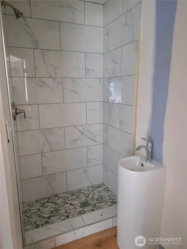 Shower in the 3/4 bathroom downstairs.