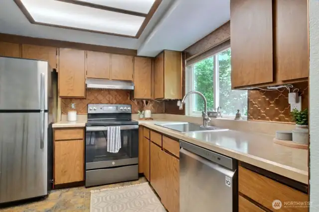 Stainless appliances and an abundance of cabinets in the kitchen.