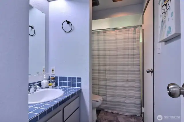 Full bath on main level opens to bedroom and hallwayl