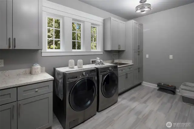 Main floor laundry with plenty of cabinet space.
