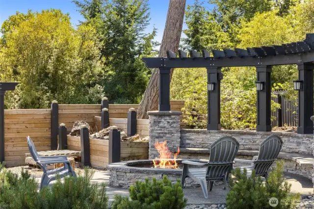 Stunning firepit and sitting area in backyard.