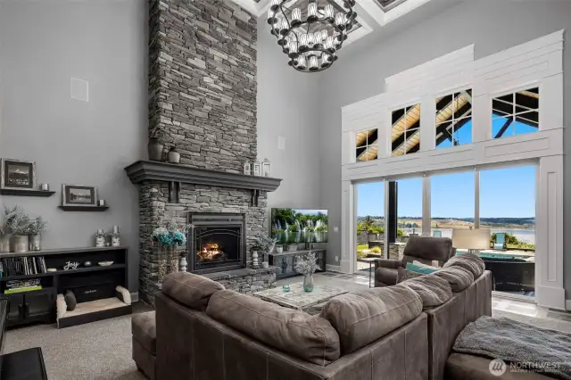 Magnificent great room with floor to ceiling fireplace and oversized windows with views of the sound and Rainier!