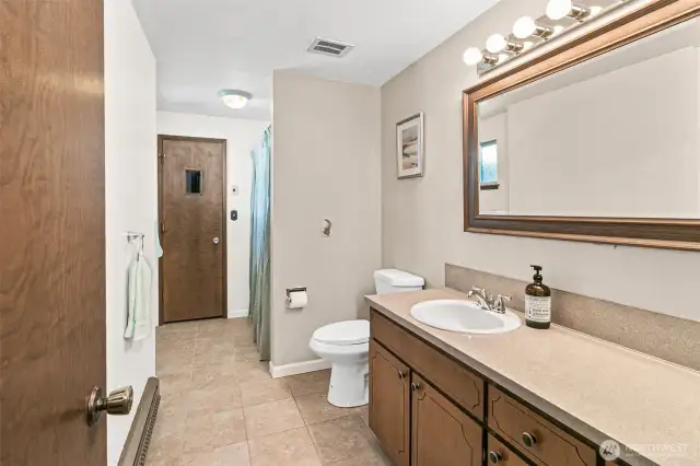 LARGE Secondary Bathroom. Freshly Painted too! That door at the end is a Sauna.