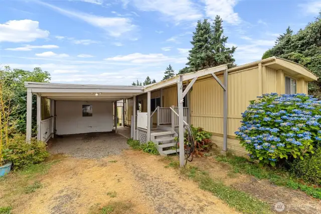 carport with 2 storage sheds.