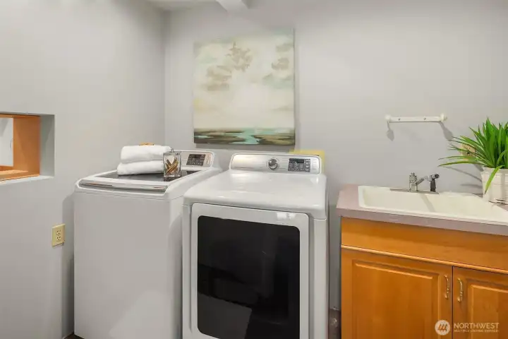 Laundry room located off the hall and has a chute off the Primary bedroom closet.