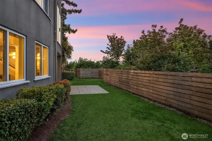 The backyard is located right off the recreation room and the family room.  The grass has been edited as it is growing in.