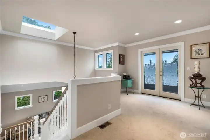 open hall way with sky light and deck