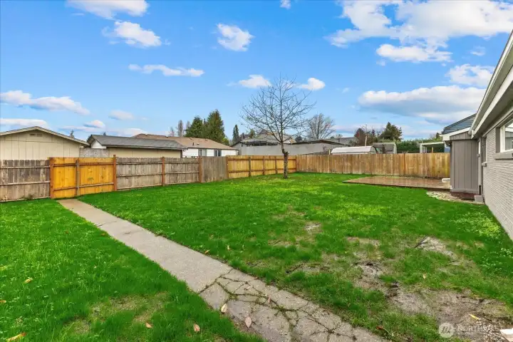 Spacious fully-fenced back yard.