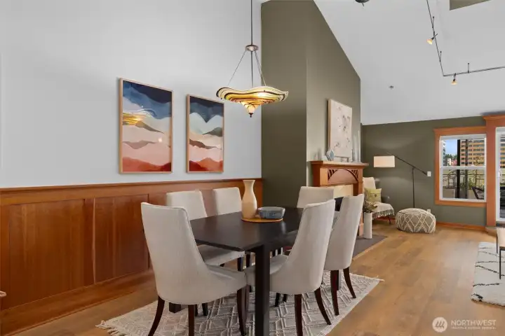 Elegant dining area framed by rich wood paneling and statement lighting—perfect for dinner parties or cozy nights in.