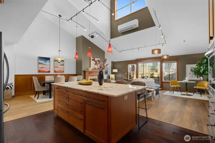 A stunning perspective of the kitchen and living area, highlighting volume, natural light, and effortless flow.