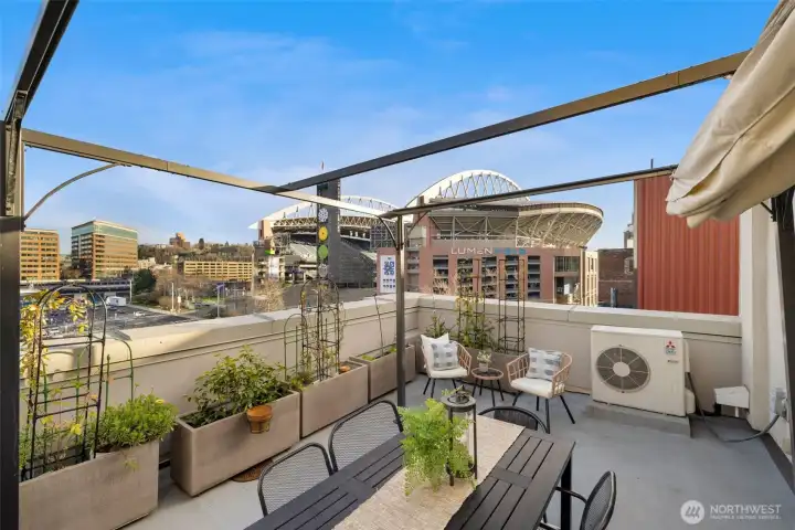 Urban rooftop oasis with awesome planters and room to customize your own outdoor sanctuary.