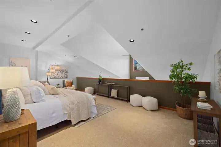 Spacious primary bedroom retreat with vaulted ceilings and room for a seating area or workspace.